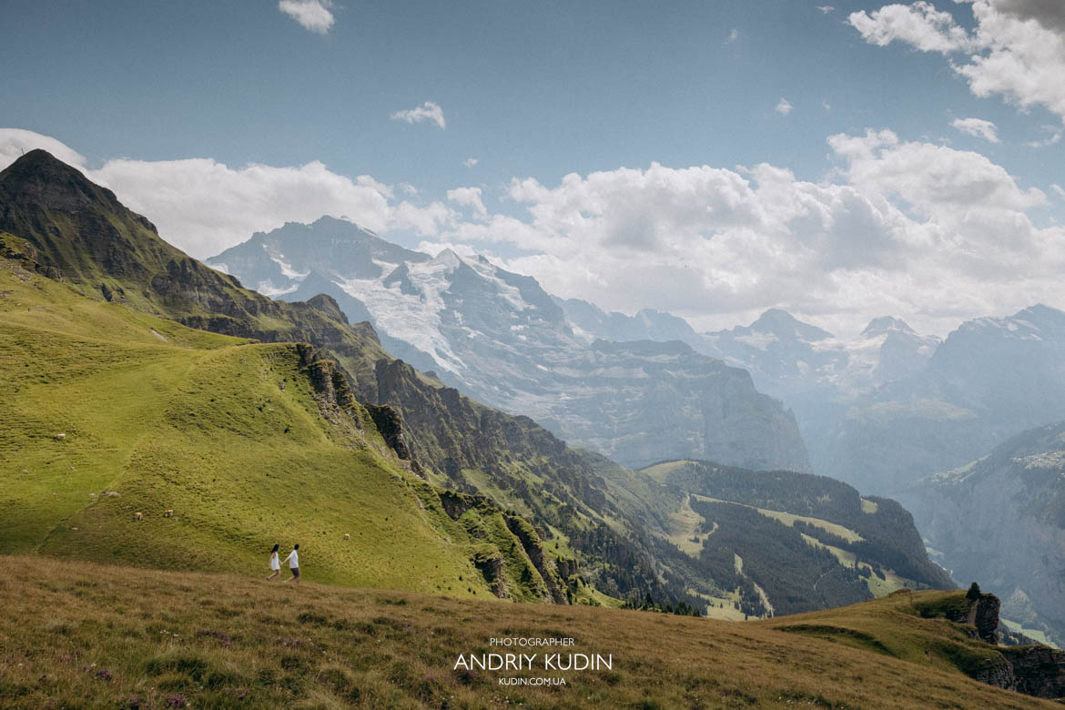 Hiking on Mannlichen slopes Couple hiking on Mannlichen slopes with Eiger Mönch and Jungfrau view by switzerland proposal photographer Andriy Kudin