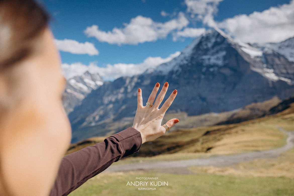 Close up of bride showing engagement ring on her hand with Eiger peak background in Grindelwald Switzerland