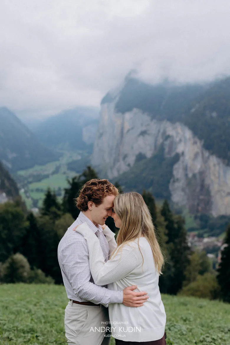 Intimate couple embrace after successful surprise proposal in Lauterbrunnen captured by switzerland proposal photographer.