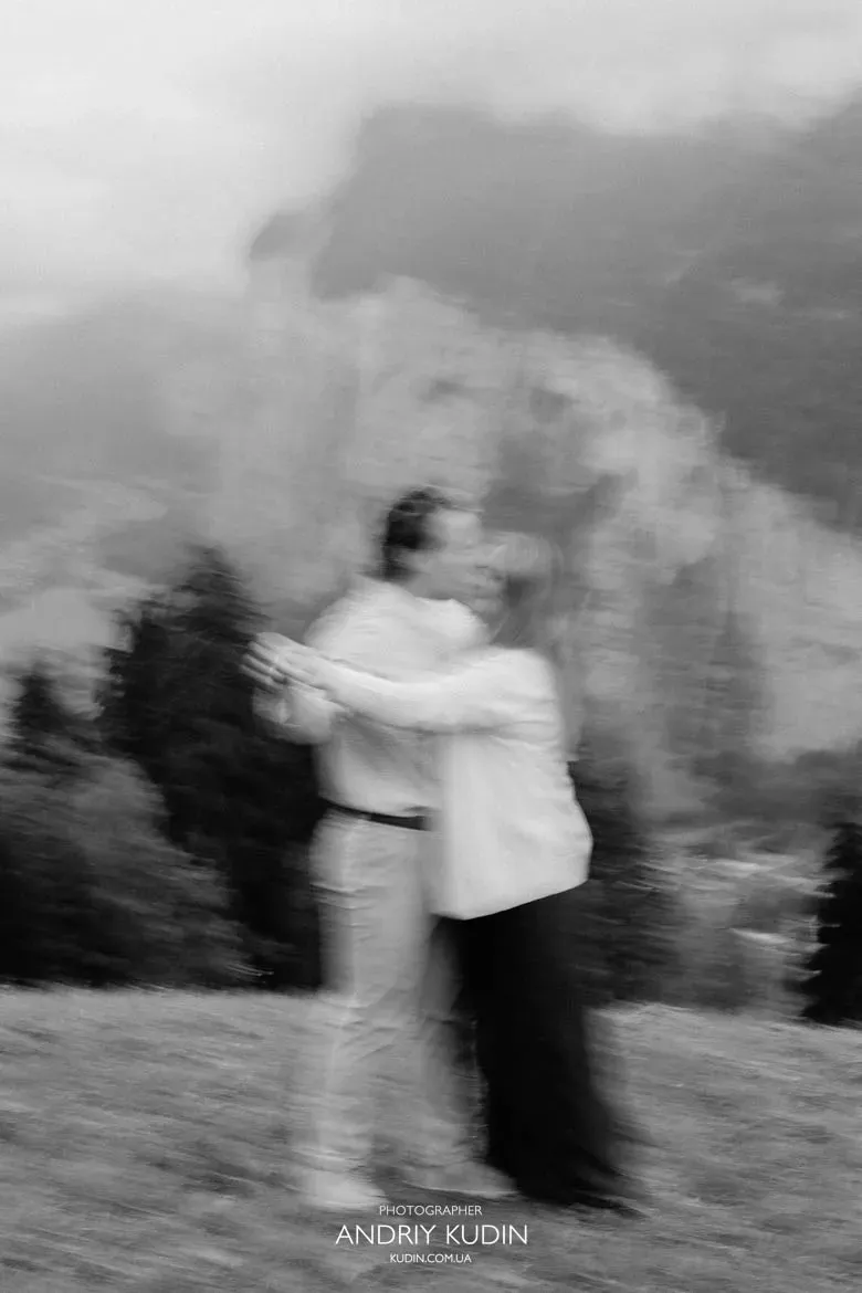 Motion blur black and white photo of romantic couple embracing in Lauterbrunnen. Photo by switzerland proposal photographer.
