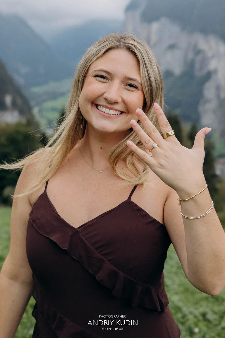 Engaged woman showing ring after proposal in Lauterbrunnen Valley. Photo by switzerland proposal photographer.